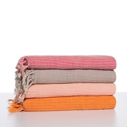Hammam towel in various colors including dark grey, pink, melon, black, taupe, raspberry, and airblue. The towel has a stonewashed texture and is made of high-quality materials.