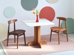 Square white dining table 80x80cm with wooden pedestal base, modern minimalist design, seats four people comfortably.