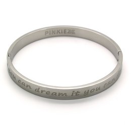 A silver-colored metal bracelet with the text "may your dream be you guide" engraved on it. The bracelet appears to be part of the Pinkiez jewelry collection.