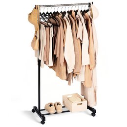  A black metal clothes rail with wheels, holding a variety of beige and neutral-colored clothing items on hangers. The rail is on wheels, allowing for easy mobility.