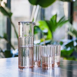 Blush pink glass carafe and glasses, elegant glassware set for serving drinks.