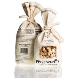 Pistachio nuts in a linen pouch, 250g. Salted and unsalted variants available. Linen pouch with natural, earthy tones. Nuts are a single type, whole pistachio variety.