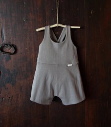  Soft green cotton baby romper with short sleeves and a ruffled collar. Available in sizes 3M to 24M in various colors including cotton flower, cinnamon, acorn, and thyme.