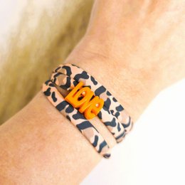  Leopard print wrap bracelet with orange beads and charms. Stylish and trendy accessory.
