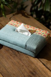 Handmade tissue box holder, light blue linen with floral patterned cork top, striped fabric detail, decorative home accessory.