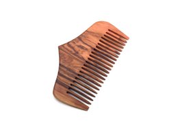Comb made of olive wood, suitable for hair brushing. Features a natural, wooden design with a sturdy, wide-toothed structure.