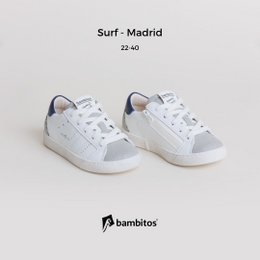 White and navy blue casual sneakers with a zipper on the inside, suitable for kids' sports activities.