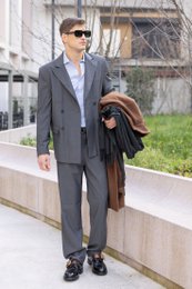  A double-breasted grey wool blazer made in Italy, suitable for men's formal wear.