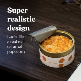 Caramel-scented candle in a round, orange container with a realistic popcorn design. The packaging features a paper top lid, making it a beautiful, ready-to-gift item.