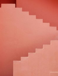 Geometric abstract painting with layered rectangular shapes in shades of pink and red.