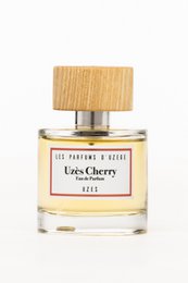 Eau de parfum with a cherry scent, presented in a glass bottle with a wooden cap.
