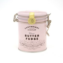 Creamy, rich butter fudge in a decorative tin container. The fudge has a smooth, buttery texture and a classic flavor.