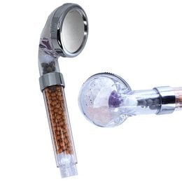 A shower curtain with a modern, minimalist design featuring a circular pattern in shades of gray. The shower head appears to have a chrome finish and includes a detachable handheld component.