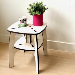 A high, round side table with a white top and black metal legs. The table has a modern, minimalist design and is suitable for use in a variety of settings.