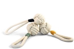 Tie the Knot Tug Toy, a durable and interactive pet toy made of natural materials in Eucalyptus Green, Mustard, and Navy colors, designed for dogs to play and chew.