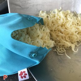 Reusable freezer bag in various colors, suitable for storing and freezing food items.