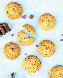 Round, golden-brown chocolate chip cookies with chocolate chips visible. Soft, chewy texture.