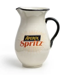  A white ceramic pitcher with the Aperol Spritz logo and branding. The pitcher has a black handle and rim, and the Aperol Spritz logo is prominently displayed in red and orange.
