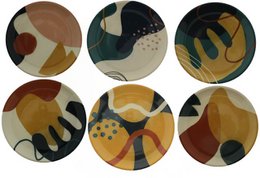 Circular side plates featuring abstract organic shapes and patterns in earthy tones of brown, beige, and black.