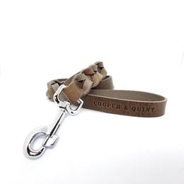 Twisted dog leash made of durable stone-colored material with Cooper & Quint branding.
