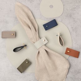 Set of 4 natural leather napkin rings in brown color. Suitable for casual or formal table settings.