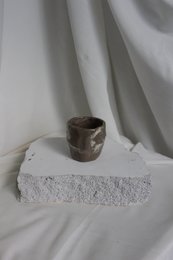 Glossy handmade ceramic cups in a minimalist, modern design. Features a simple, curved shape with a neutral color palette.