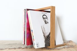 Vinyl storage rack with two shelves, made of wood, holding vinyl records.