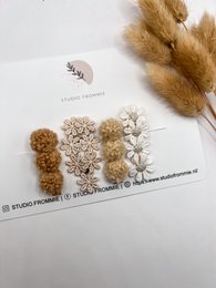 Assorted hair clips featuring a variety of floral designs in neutral tones. Includes clips in beige, white, and light brown shades.