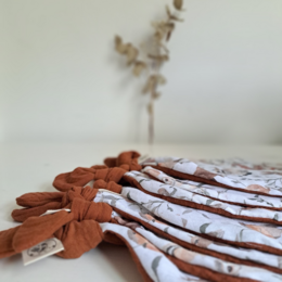  Soft, plush cuddle cloth featuring a forest friends design with neutral tones and nature-inspired patterns. Ideal for comforting and soothing young children.