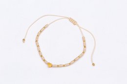  Gold chain bracelet with adjustable cord, delicate minimalist design, beaded link style.