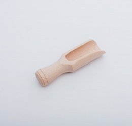 Small wooden scoop with sensory pebbles. Textured, natural materials for tactile exploration and sensory play.