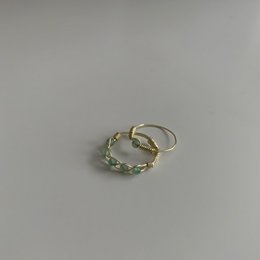 Green stone ring with a twisted metal band.