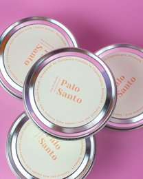 Medium-sized, scented soy candles with a Palo Santo fragrance, presented in a round, silver-colored tin.