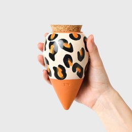 Leopard-patterned ceramic plant pot with a cork lid, suitable for indoor plants or succulents.