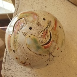 Decorative ceramic ball with stylized bird designs, available in various sizes, suitable as a unique table lamp or home decor item.