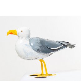  Medium-sized metal seagull bird feeder with yellow beak and feet.