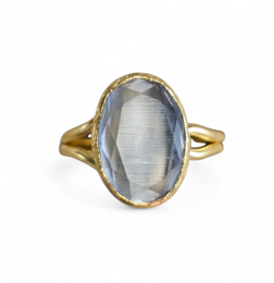  Grey oval gemstone ring, gold band, luminous glow effect, elegant statement piece