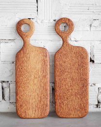 Rectangular palm wood cutting board with natural wood grain texture.