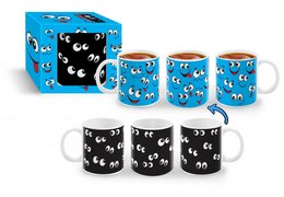 A set of blue mugs with black and white cartoon faces printed on them. The mugs come in a blue box with the same cartoon face design.