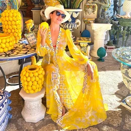 Vibrant yellow floral beach kimono with a flowing, airy design perfect for summer. Lightweight and comfortable material, ideal for covering up at the beach or pool.