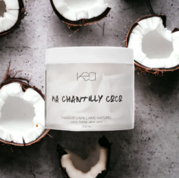 Coconut-based hair mask in a white container with the product name "Ma chantilly coco 300ml" printed on it. The product is surrounded by sliced coconut halves.