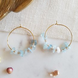 Elegant drop earrings featuring a gold-tone hoop with aquamarine and pearl beads. Ideal for formal or casual wear.