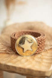 Tan leather belt with a gold star-shaped buckle. The belt has a textured, woven design.