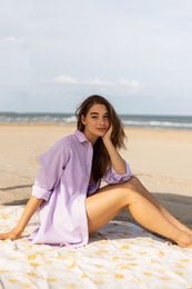 Lightweight, relaxed-fit blouse in a soft lavender hue with a button-down front and 3/4 sleeves.