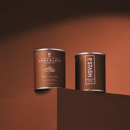 Dark chocolate-covered almonds with cinnamon and orange flavors, presented in a mini 60g tin.