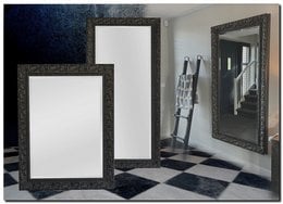 Antique black framed mirror with various size options for wall decor in a living room setting.