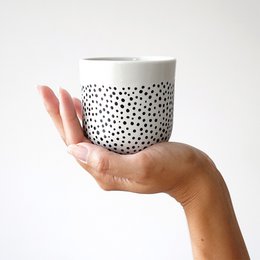  Porcelain cup with a dotted pattern, suitable for hot and cold beverages.