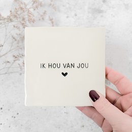  Decorative tile with the text "Ik hou van jou" (I love you) in a heart-shaped design. The tile is made of a light-colored material and has a simple, minimalist style.