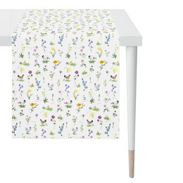 A white and colorful table runner with a floral and butterfly pattern, suitable for a dining table or other home decor.