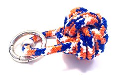 Colorful paracord keychain with a ship button design in orange, blue, and white. The keychain features a braided, textured pattern that adds visual interest.